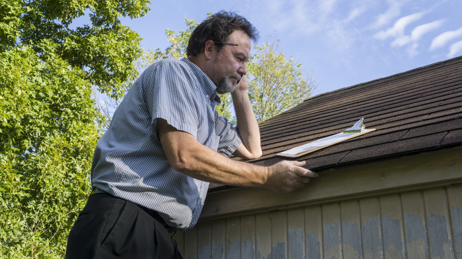 Insurance adjuster inspecting a roof